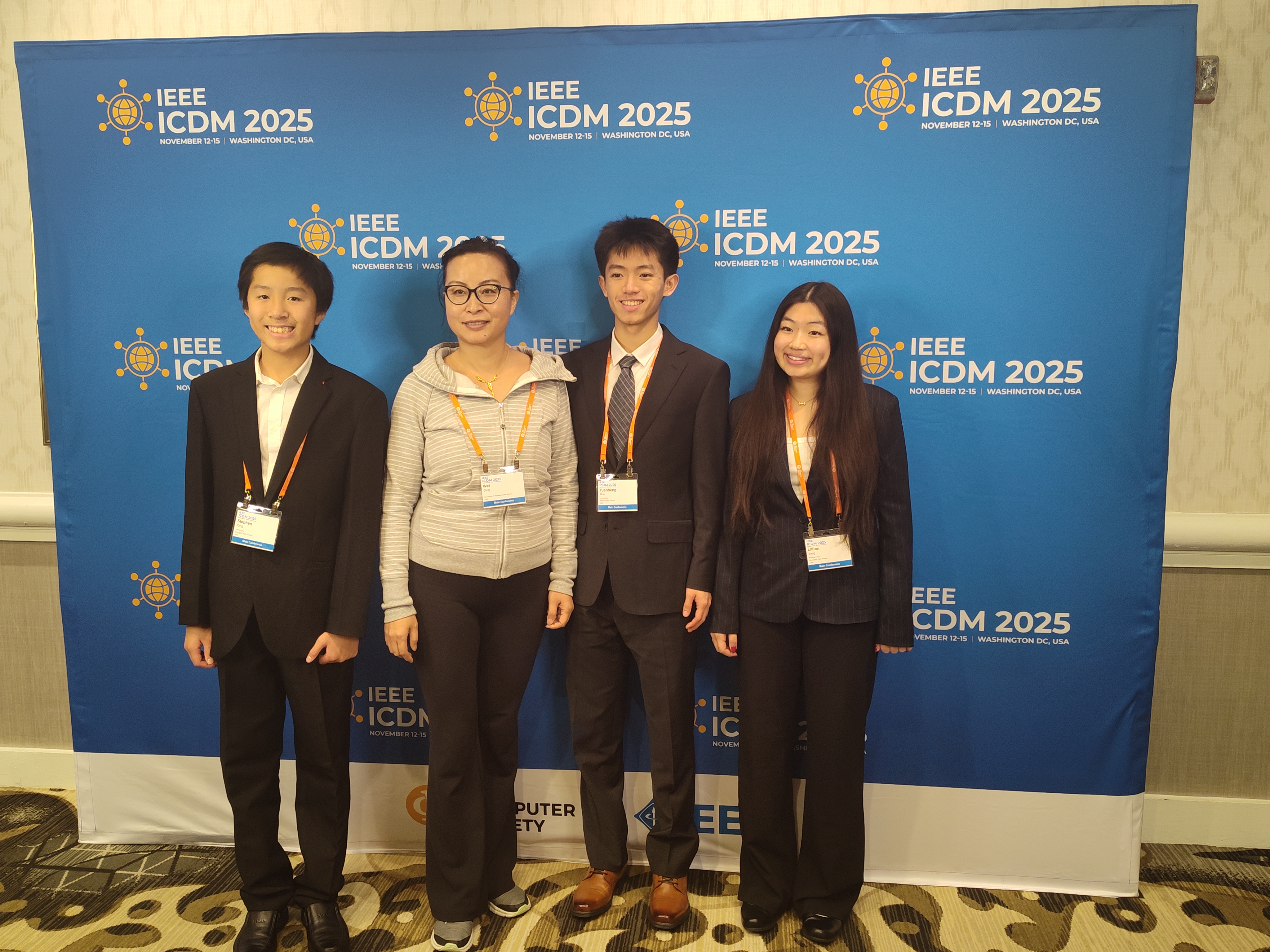 The team and professor Wei Ding taking a group photo at the IEEE ICDM 2025 site. From left to right: Stephen Yang, Wei Ding, Yuanheng Mao, Lillian Yang